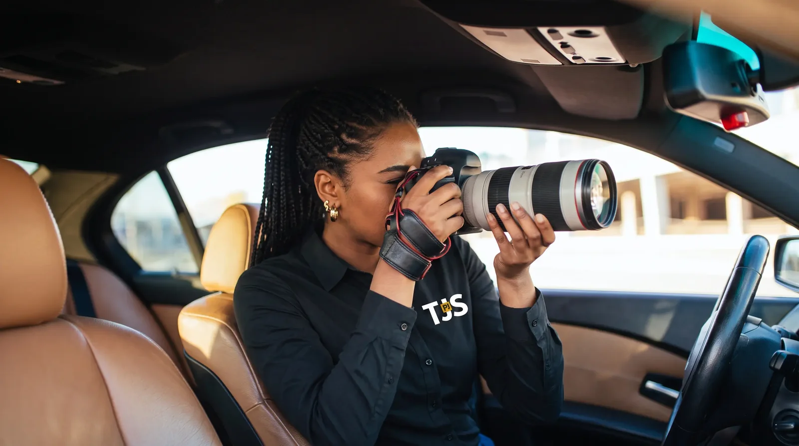 TJS investigator conducting surveillance from a vehicle